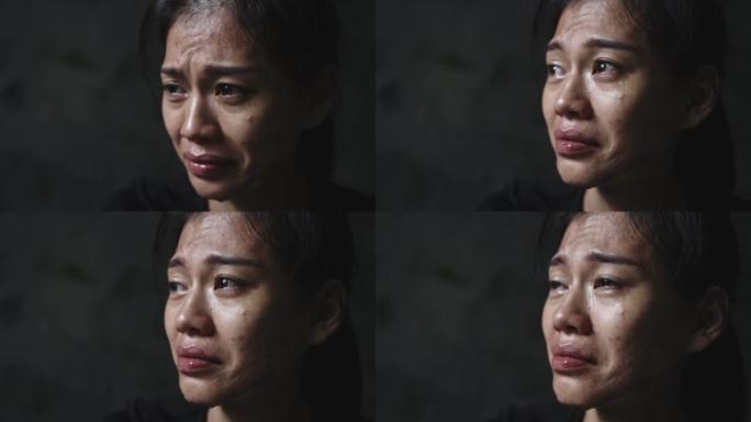 一个女人哭泣的特写镜头，眼泪从脸上流下来。制止暴力侵害妇女、贩运人口、强奸的概念。