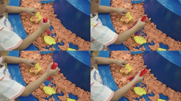 快乐的亚洲儿童在娱乐中心玩耍充气城堡在检疫玩动感沙