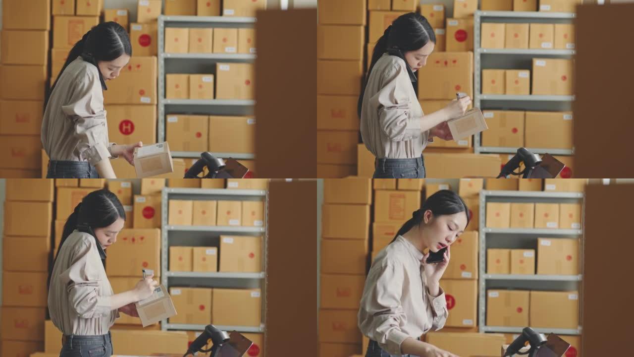 Asian woman working at online store warehouse usin