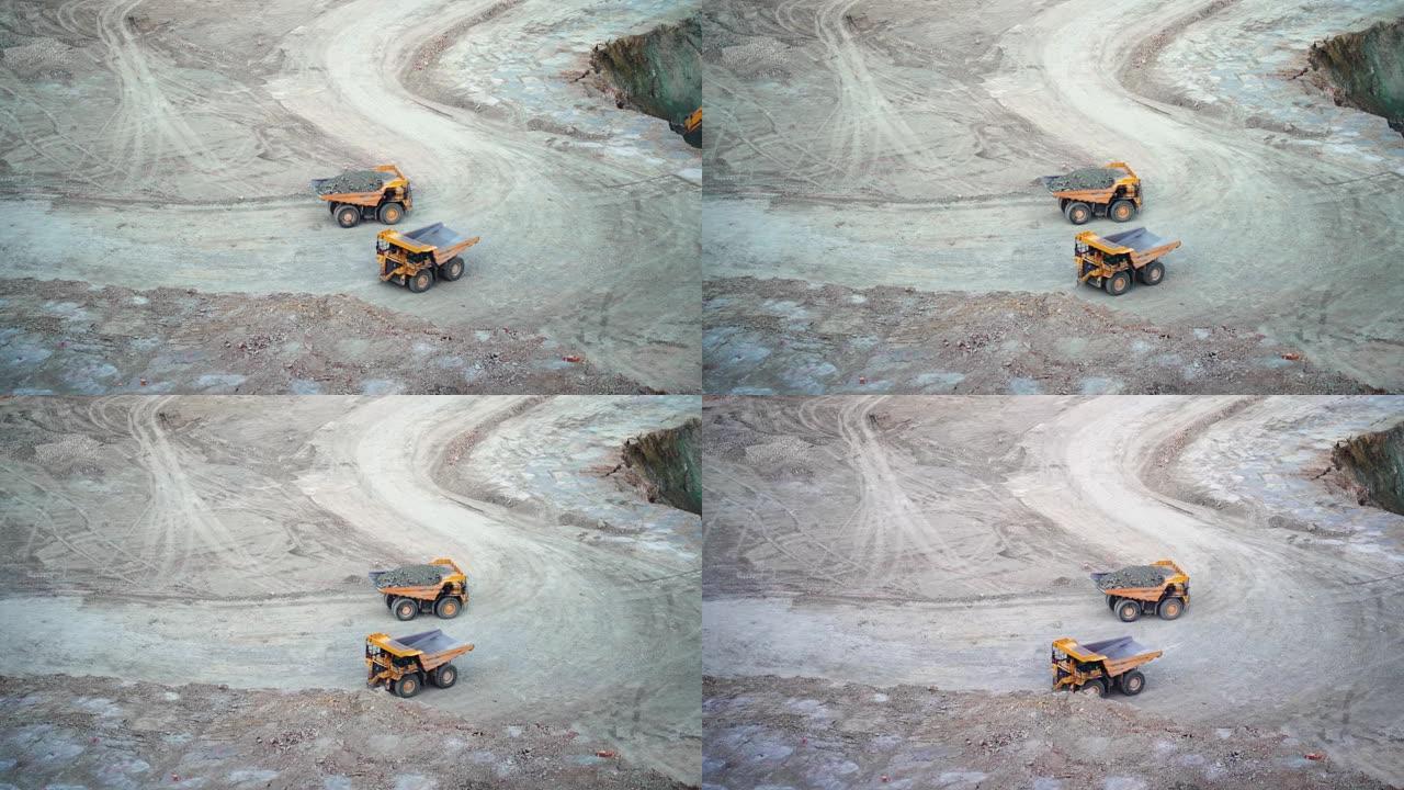 重型采矿自卸车沿露天矿井行驶，慢动作