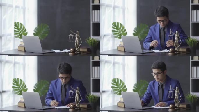 从具有法律服务概念的亚洲商业律师开始您的一天，在线咨询办公室配有笔记本电脑和锤子，以判断正义女神。