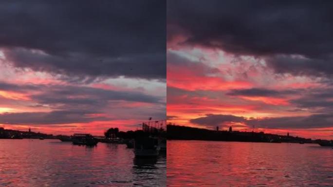 垂直拍摄视频，低亮度的日出和美妙的红色多云天空