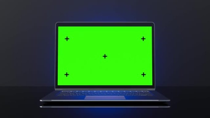 金属笔记本电脑模型和蓝光放置在黑色背景上。
