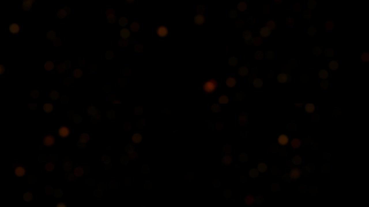 抽象动画模糊橙红色散景气泡粒子在黑色背景上闪烁。4K 3D无缝循环橙红色散景颗粒灰尘在空气中飞行。