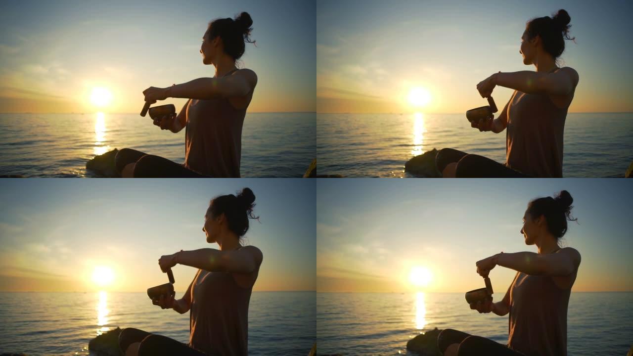 健康少女冥想藏族唱盘海边日出慢动作