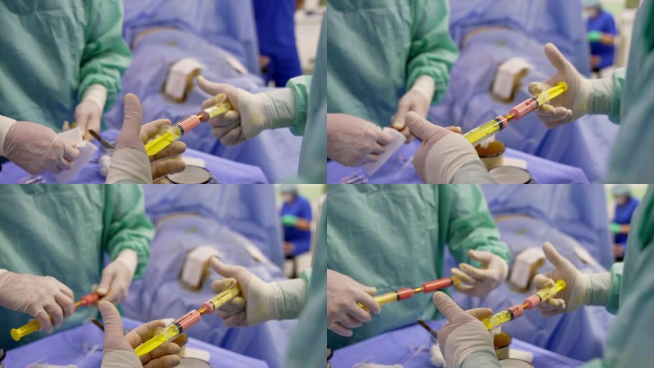 两个手里拿着注射器的医生。专家将干细胞从一个注射器移动到另一个注射器混合。特写。