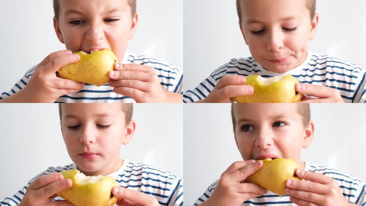 一个可爱的小男孩在白色墙壁上吃多汁梨的肖像。高质量4k视频