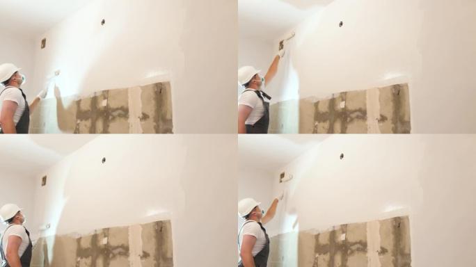 专业建筑商，在工作时对墙壁进行滚轴粉刷。现代维修