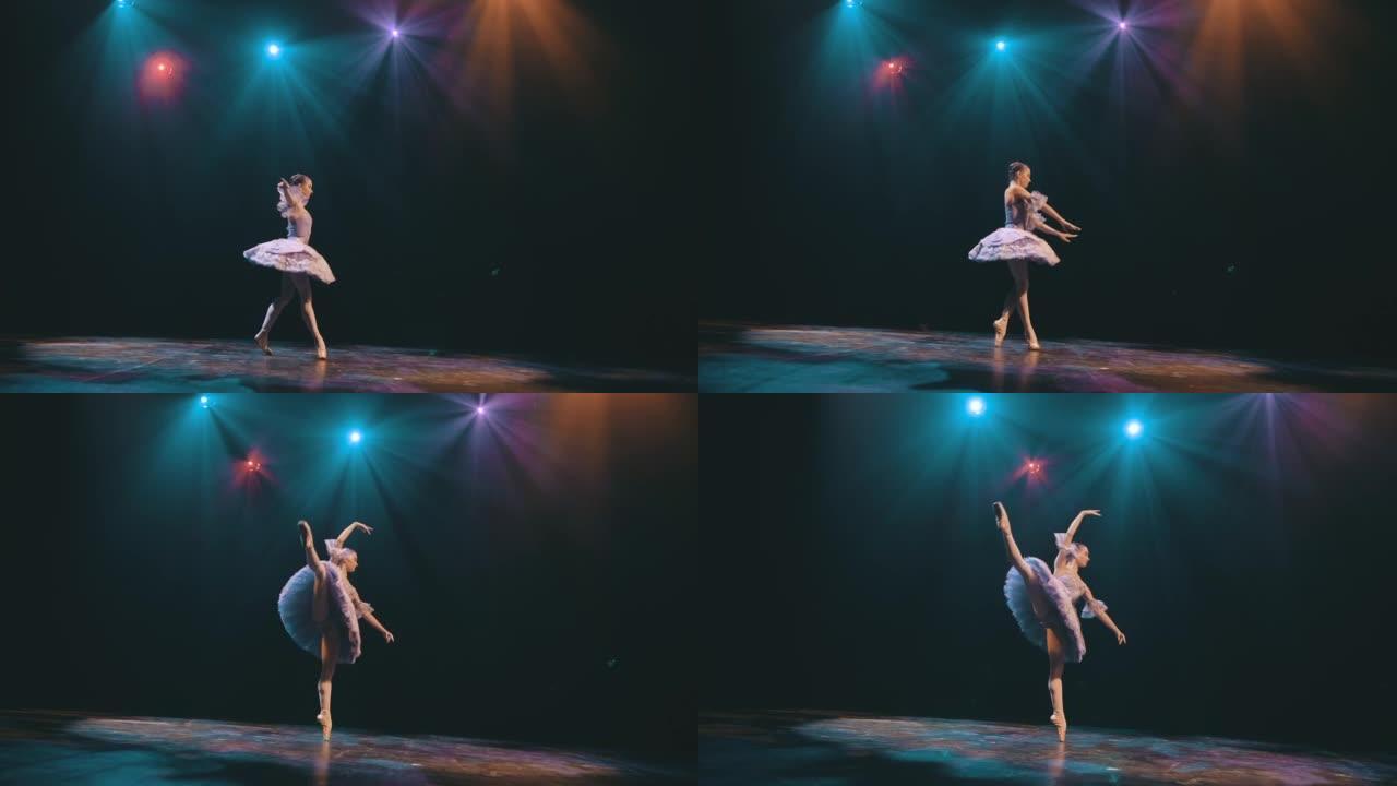 芭蕾。单色。优美的芭蕾舞演员在美丽的灯光和烟雾背景下跳舞古典芭蕾舞的元素，