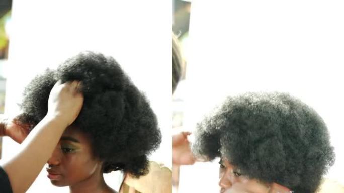 一名年轻女子在沙龙里调整了她的非洲假发