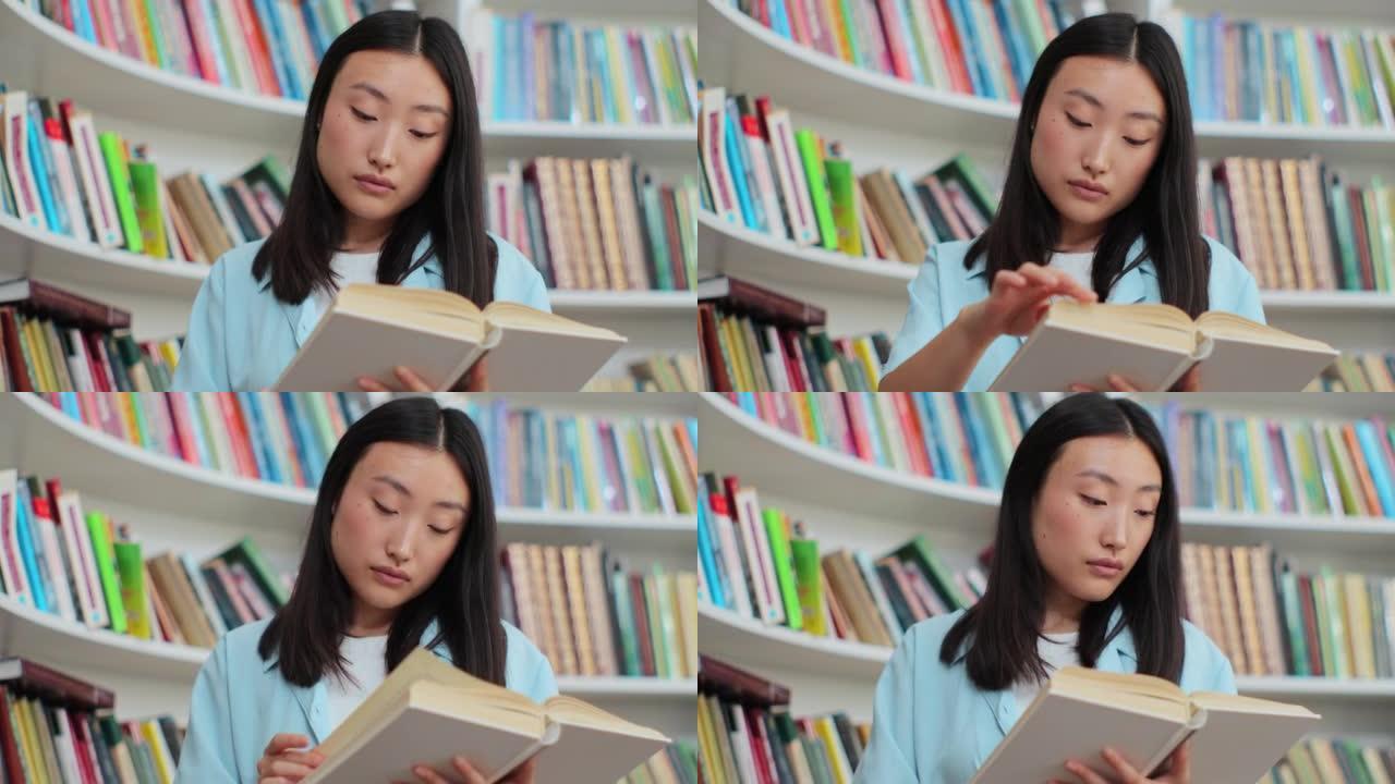 在大学图书馆书架附近的读书中关闭美丽的亚洲女孩。自我教育理念。