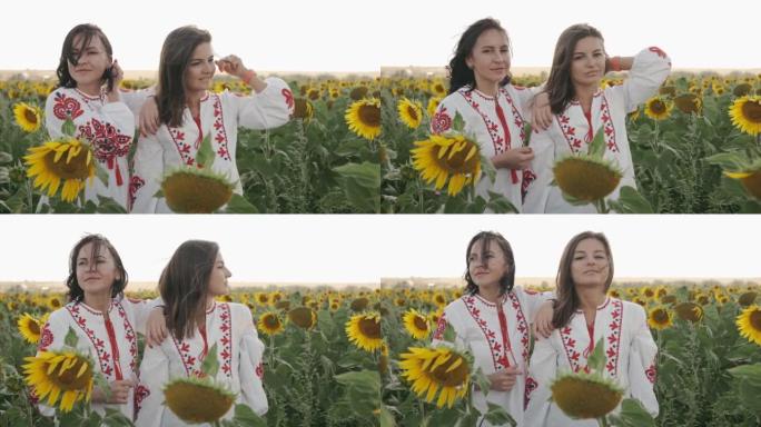 日落时分，两个穿着绣花衬衫的乌克兰年轻女性朋友的肖像走在向日葵的田野中