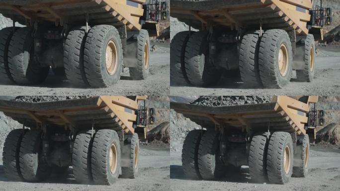 操作员在金矿场驾驶重型自卸车采矿设备，慢动作