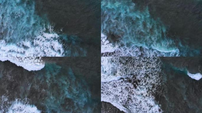 白色水洗的大功率黑暗海浪的鸟瞰图。冲浪者的空中俯视图镜头赶上了海浪。暴风雨中的神话般的海潮