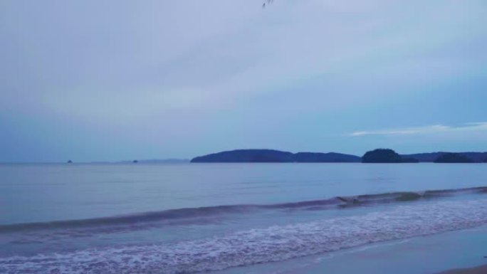 在雨天的傍晚，大海和沙滩将山脉视为遥远的标签，甲米府奥南海滩