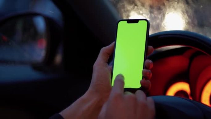 特写男子手持智能手机绿色样机屏幕车内色度钥匙