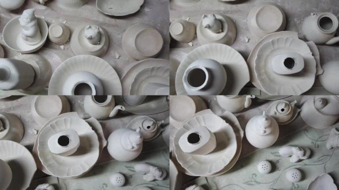 瓷器和陶瓷厂。杯子，茶壶和水罐的粘土坯料在桌子和架子上干燥。