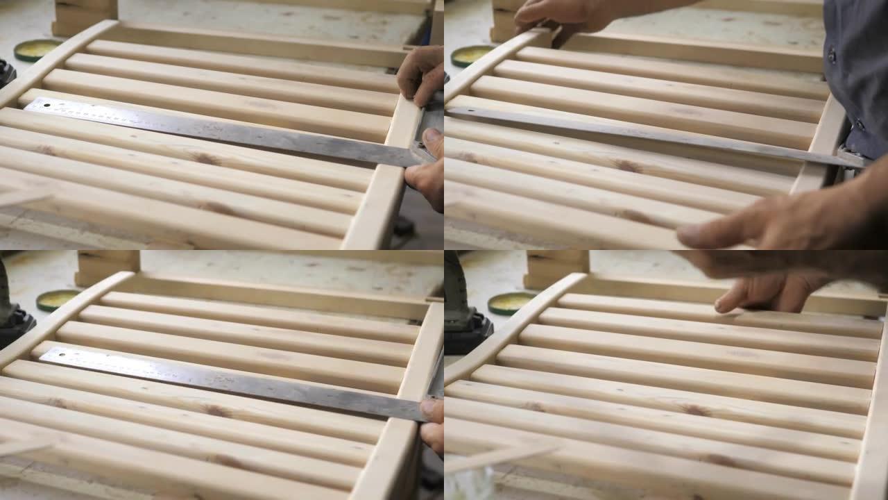 木匠的特写镜头将两个螺丝夹拧紧到一块轻木头上。专业木匠从木头上收集家具零件。在木工车间组装家具。手工