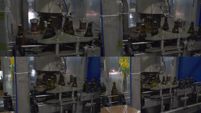 自动制造机器在装有酒精饮料的瓶子上盖上盖子