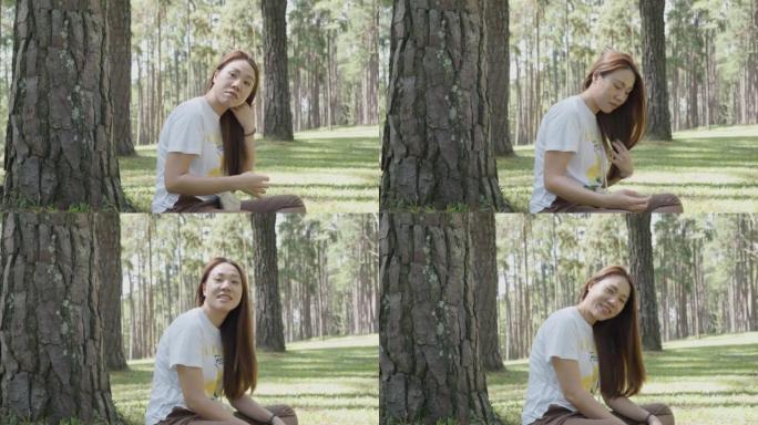 假期期间在Kaeo松树花园享受放松的东南亚女人的4k视频媒体镜头