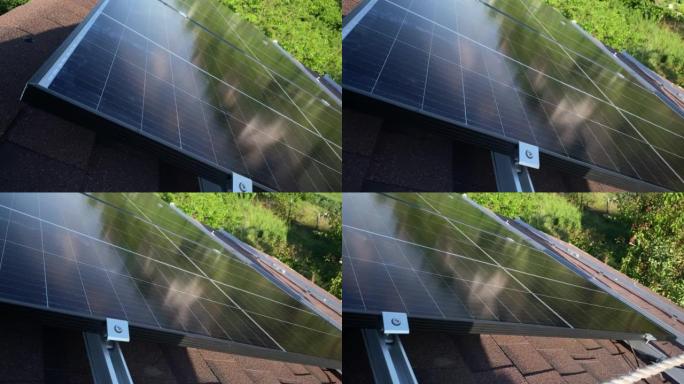 光伏太阳能电池板在小型房屋沥青瓦屋顶上的安装过程。清洁绿色可再生能源DIY