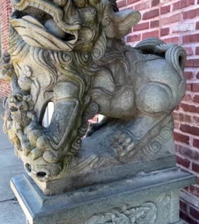 Stone statue of a Chinese lion in the port with a 