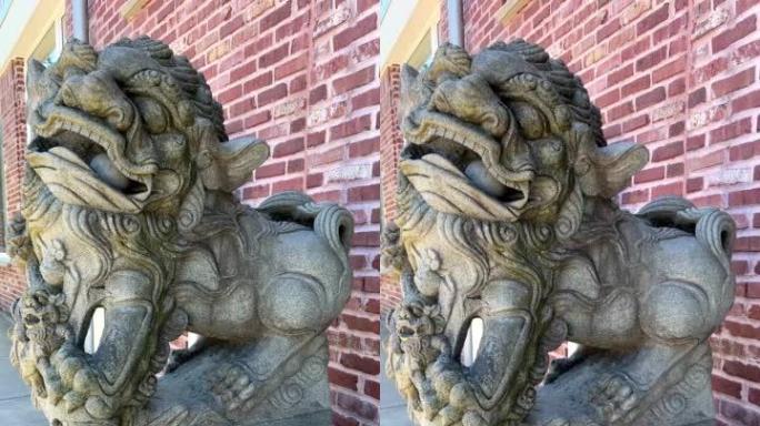 Stone statue of a Chinese lion in the port with a 