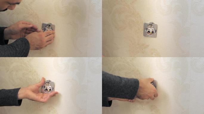 电工拆开墙上的插座。一个小时丈夫的概念。电气安装工程。用螺丝刀将插座安装在墙上的手。高质量4k镜头