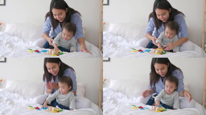Mother teaching daughter to playing with toy for p