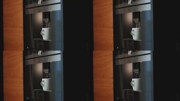 现代智能电动咖啡机将咖啡倒入家里厨房的杯子中。女性拿着成品饮料。特写