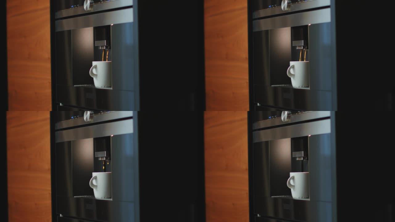 现代智能电动咖啡机将咖啡倒入家里厨房的杯子中。女性拿着成品饮料。特写