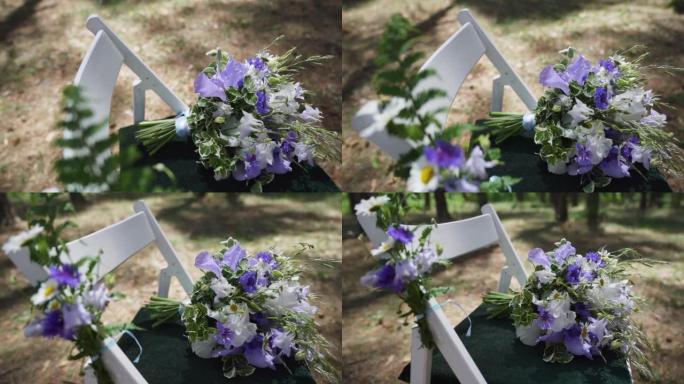 椅子上的婚礼装饰，白色椅子上的丝带和野花。