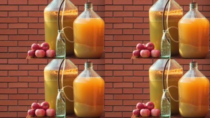 苹果酒。瓶中苹果酒的泡沫，发酵。苹果汁放在发酵罐中，带有原始的气闸。农夫在家生产苹果酒，户外特写