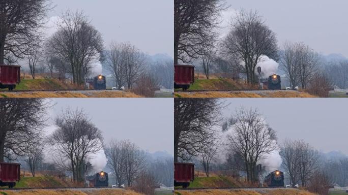 蒸汽旅客列车绕过弯道的长远视野，在冬天的日子里冒烟