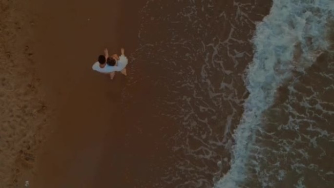 Aerial view of a romantic couple embracing in love