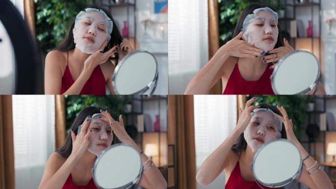 影响者记录美容教程将面膜应用于面部使用环形光电话记录博主谈论护肤品用手指按摩面部