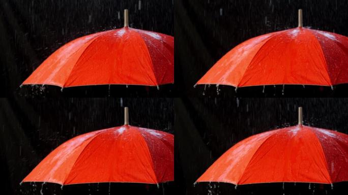 慢动作的橙色雨伞上的雨滴