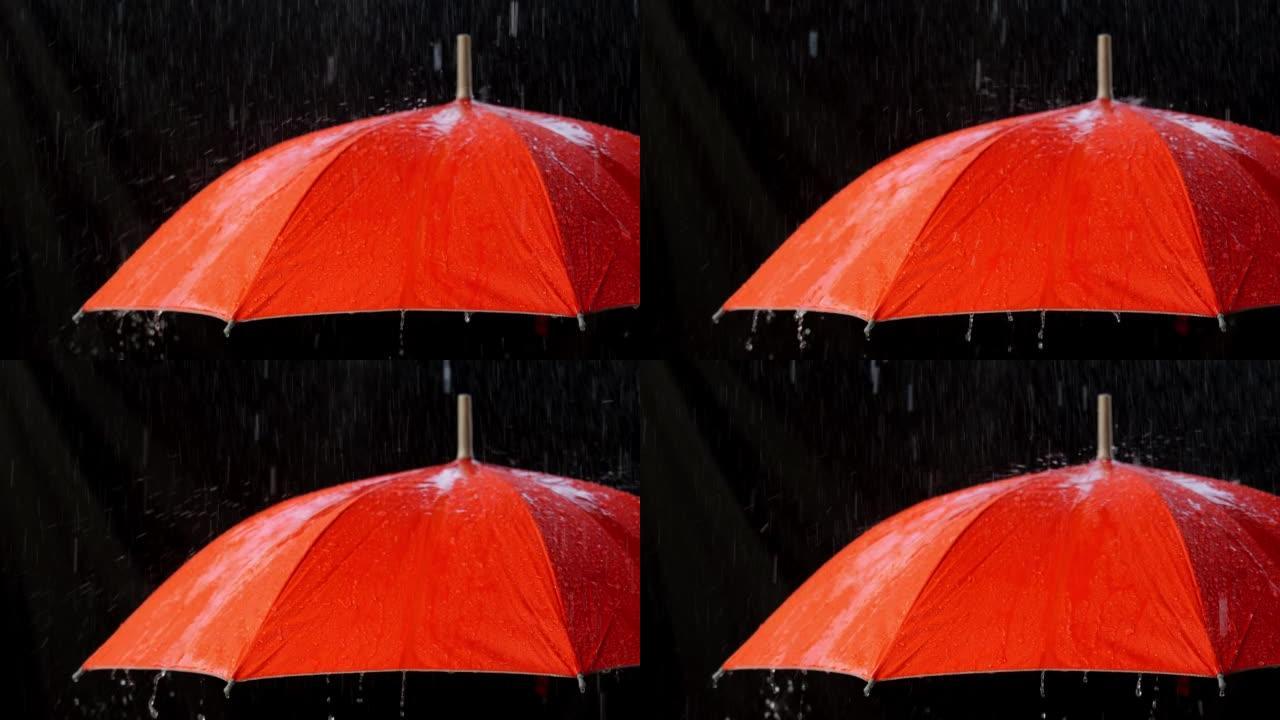 慢动作的橙色雨伞上的雨滴