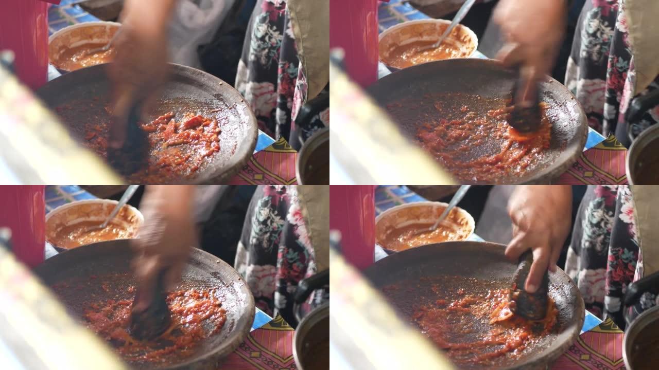 用凡人和研杵制作桑巴。Sambal是一种印尼辣椒酱或糊状物，通常由多种辣椒和次要成分的混合物制成。