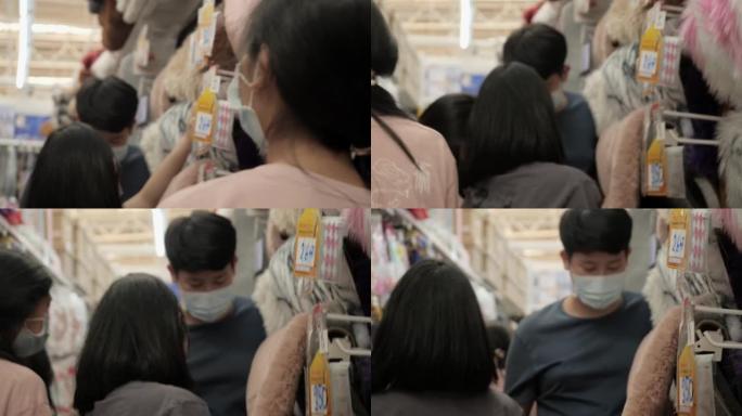 亚洲儿童戴着口罩看地毯挂在家具店一起，购物的生活方式理念。