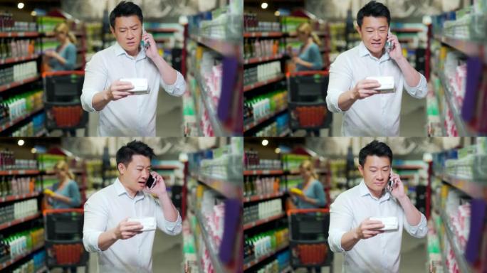亚洲年轻人在超市里选择个人护理卫生用品。丈夫打电话给妻子寻求建议。很难选择。男性制造购买商品选择