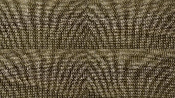 棕色针织面料质地。特写细节毛衣面料背景。冬季时尚背景柔软羊毛纺织图案