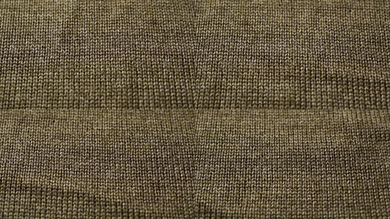棕色针织面料质地。特写细节毛衣面料背景。冬季时尚背景柔软羊毛纺织图案