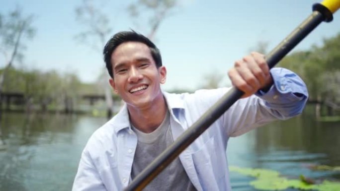 亚洲男子暑假在红树林皮划艇的4k肖像。