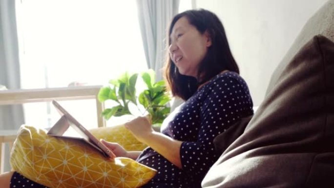 Asian woman using digital tablet making video call
