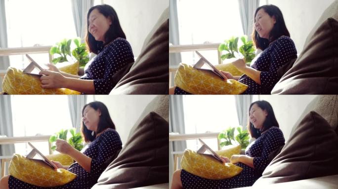 Asian woman using digital tablet making video call