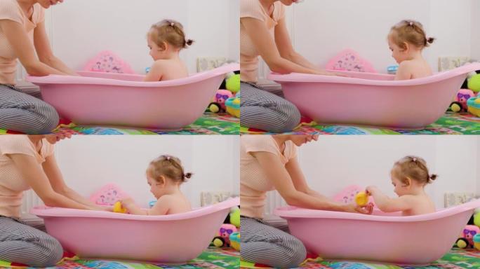 侧视母女孩子宝宝睡前晚上洗澡仪式玩水