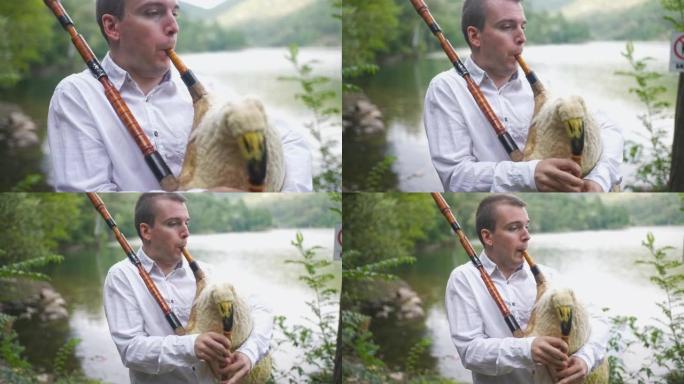 男性在风笛上播放传统歌曲时看着湖景