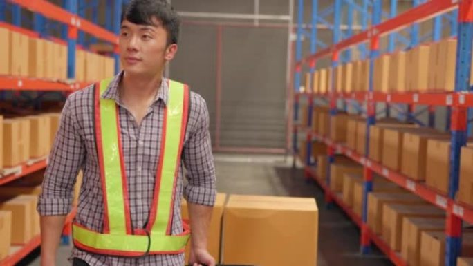 Following shot of a male industrial worker walking