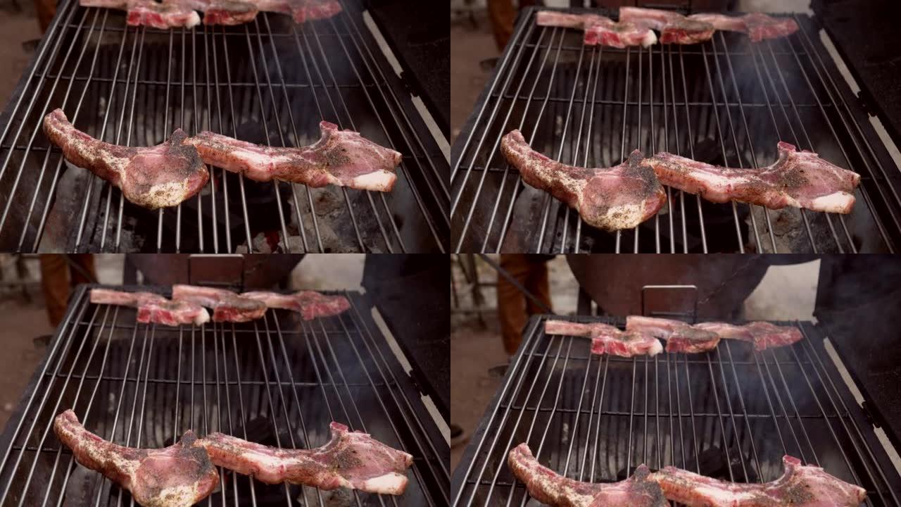 烹饪生猪排和排骨牛排在花园户外派对食物的炉子烧烤烤架上烧烤
